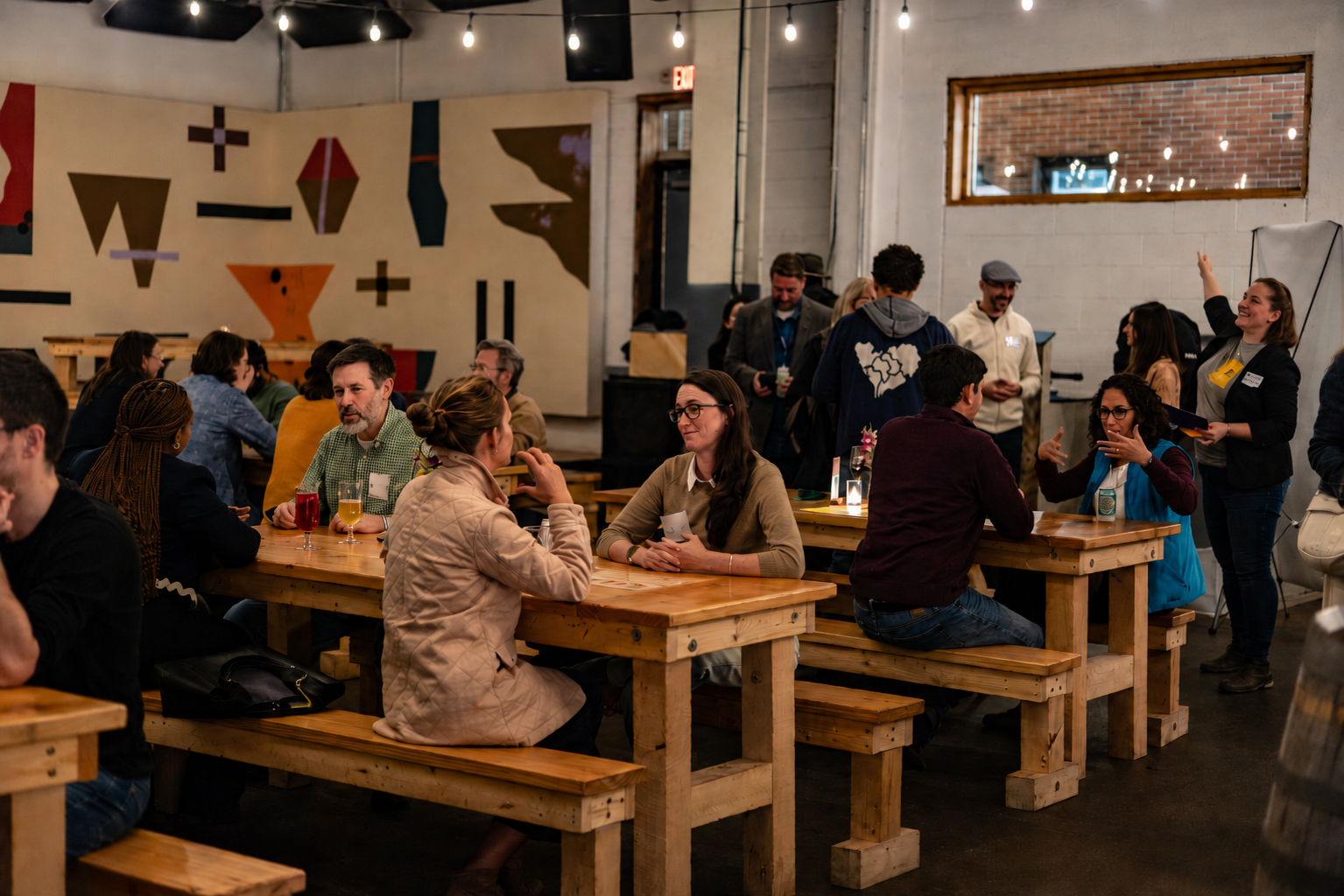 Participants in conversation at long tables during Maine Tech Week 2025